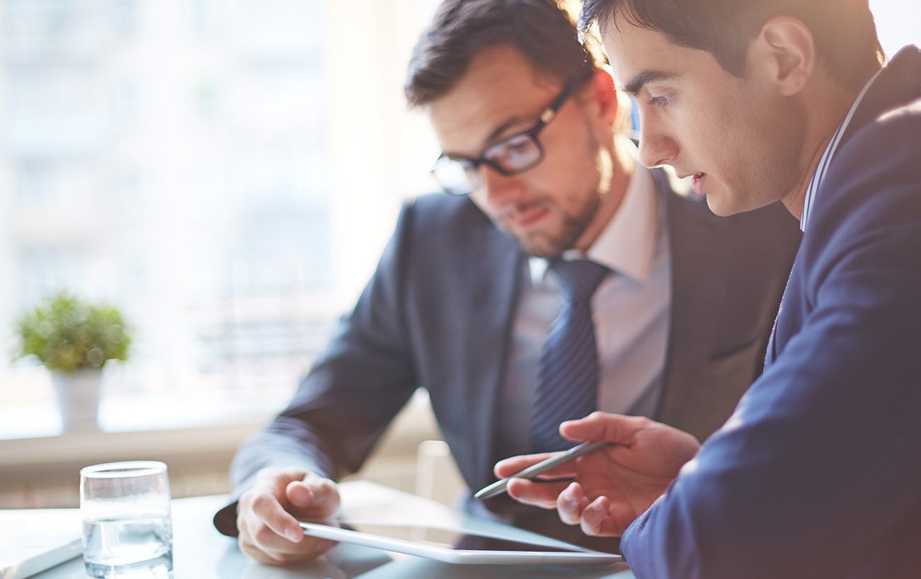 Two men looking over a document.